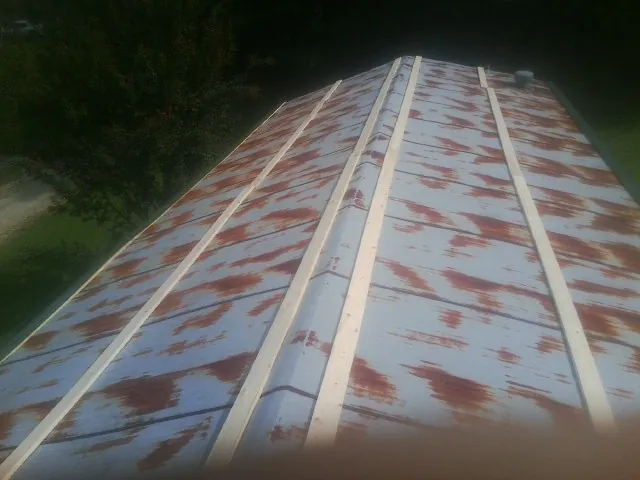 Rusted metal roof panels with new wood purlins before replacement — Storm Damage Roof Repair in Lecompton by Roofing Brothers